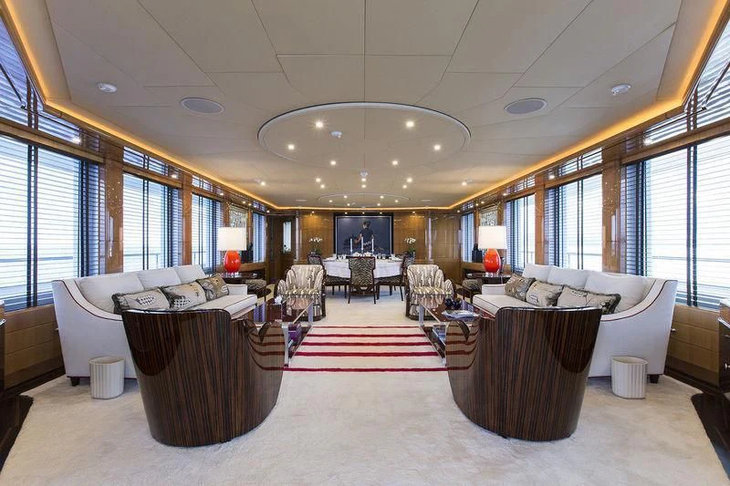 a large living room with a red rug aboard LADY MM Yacht for Sale