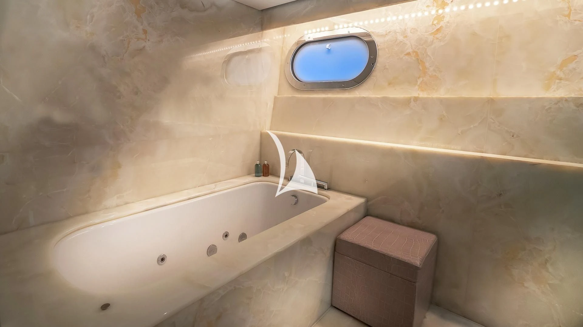a bathroom with a tub and a toilet aboard ODESSA Yacht for Sale