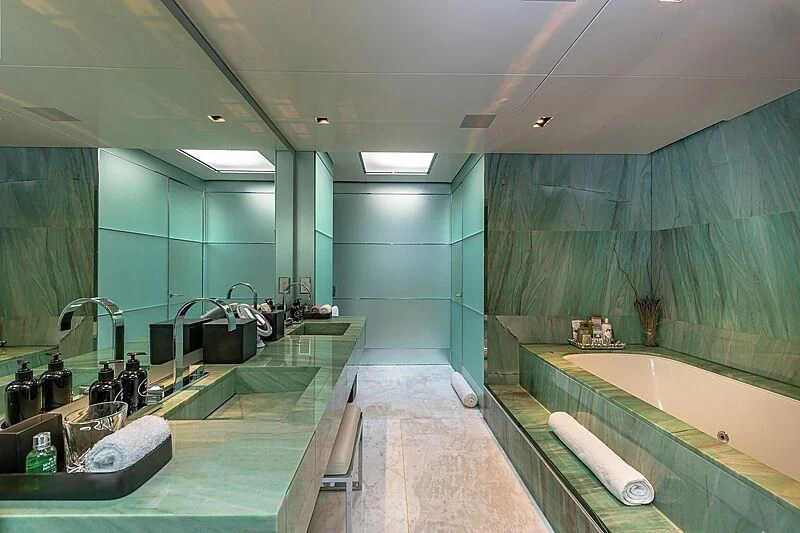 a bathroom with a tub sink and a large mirror aboard ODESSA Yacht for Sale
