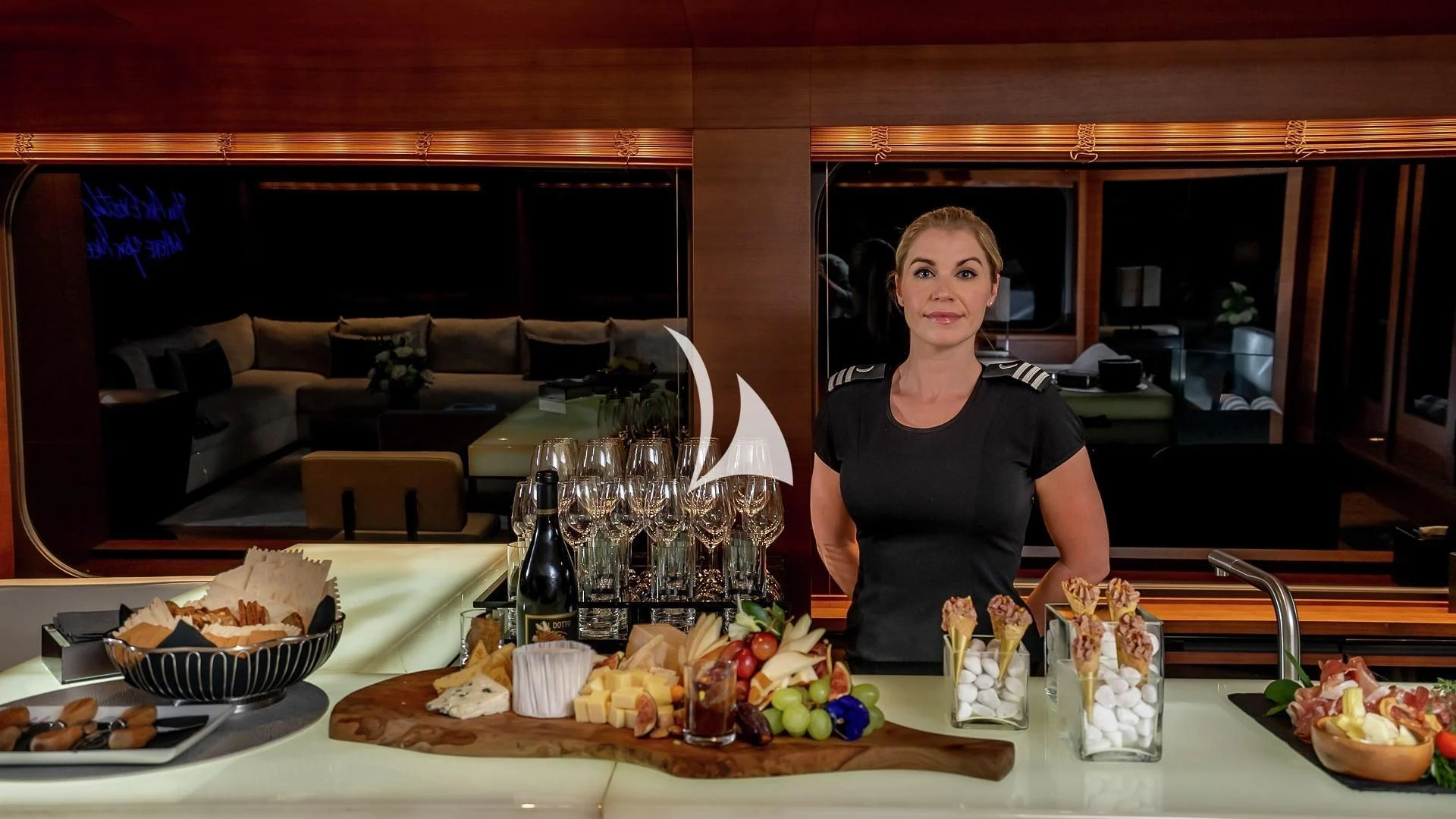 a person standing behind a table full of food aboard ODESSA Yacht for Sale