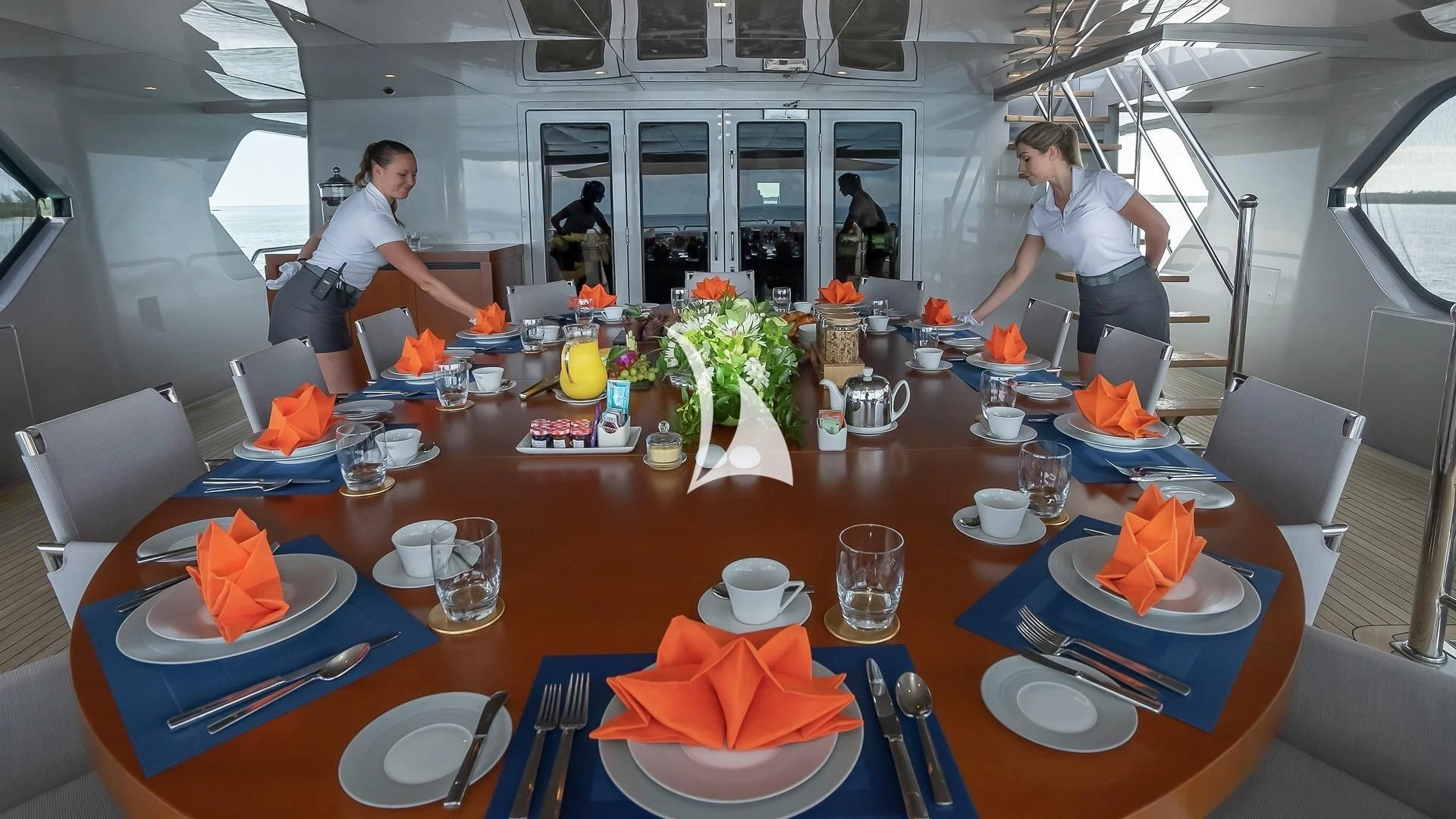 a table with plates and glasses aboard ODESSA Yacht for Sale