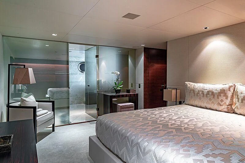a bedroom with a bed and a desk aboard ODESSA Yacht for Sale