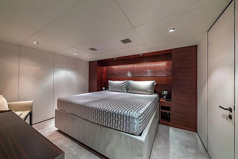 a bedroom with a bed and a desk aboard ODESSA Yacht for Sale