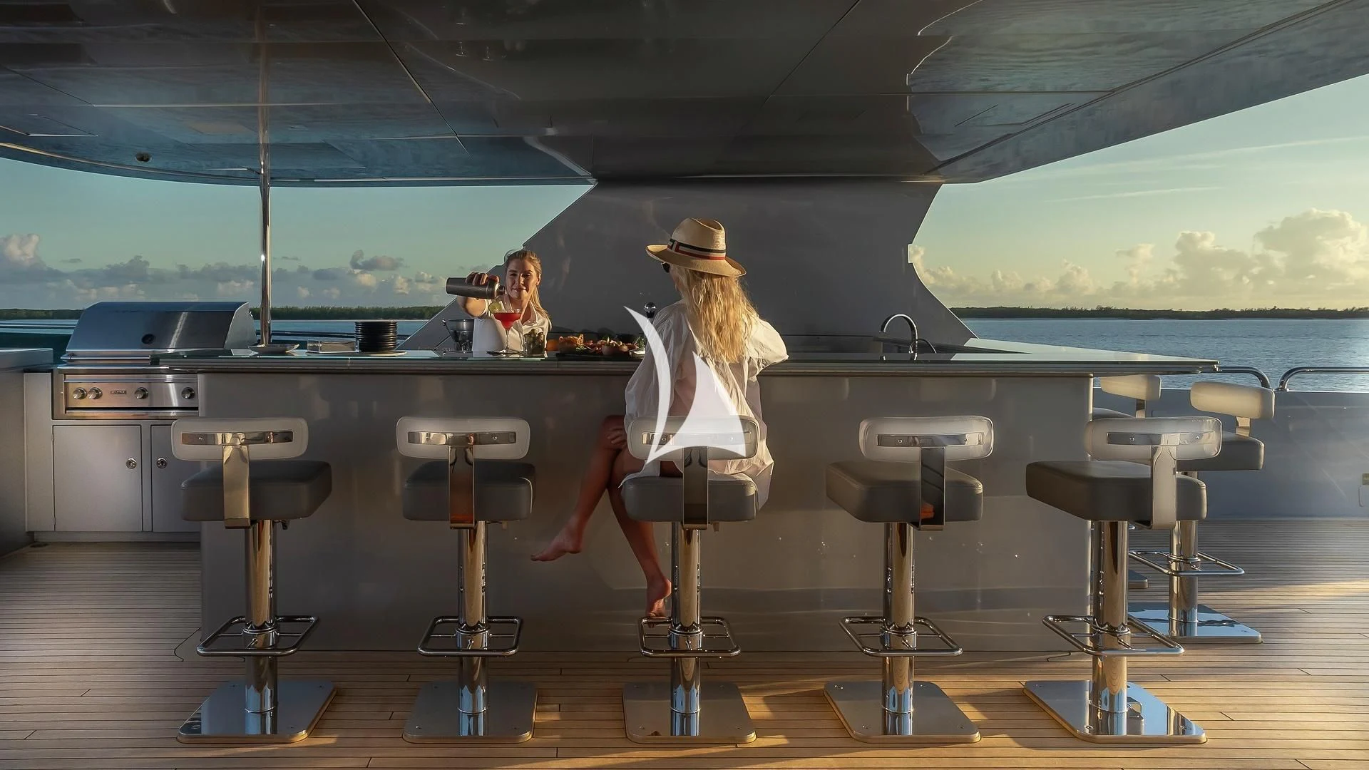 a man and woman sitting at a table in a restaurant aboard ODESSA Yacht for Sale