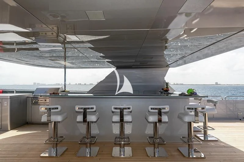 a room with stools and stools and a large window aboard ODESSA Yacht for Sale