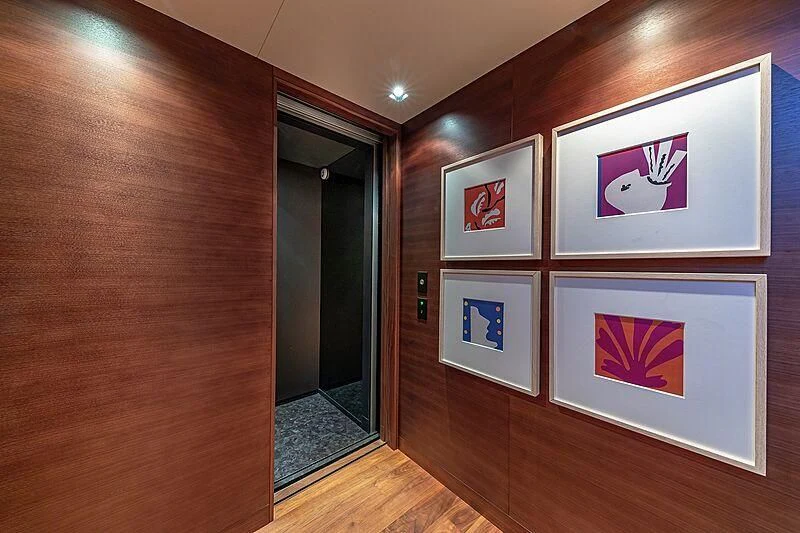 a room with paintings on the wall aboard ODESSA Yacht for Sale