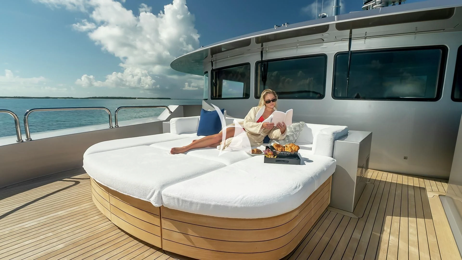 a person sitting on a bed aboard ODESSA Yacht for Sale