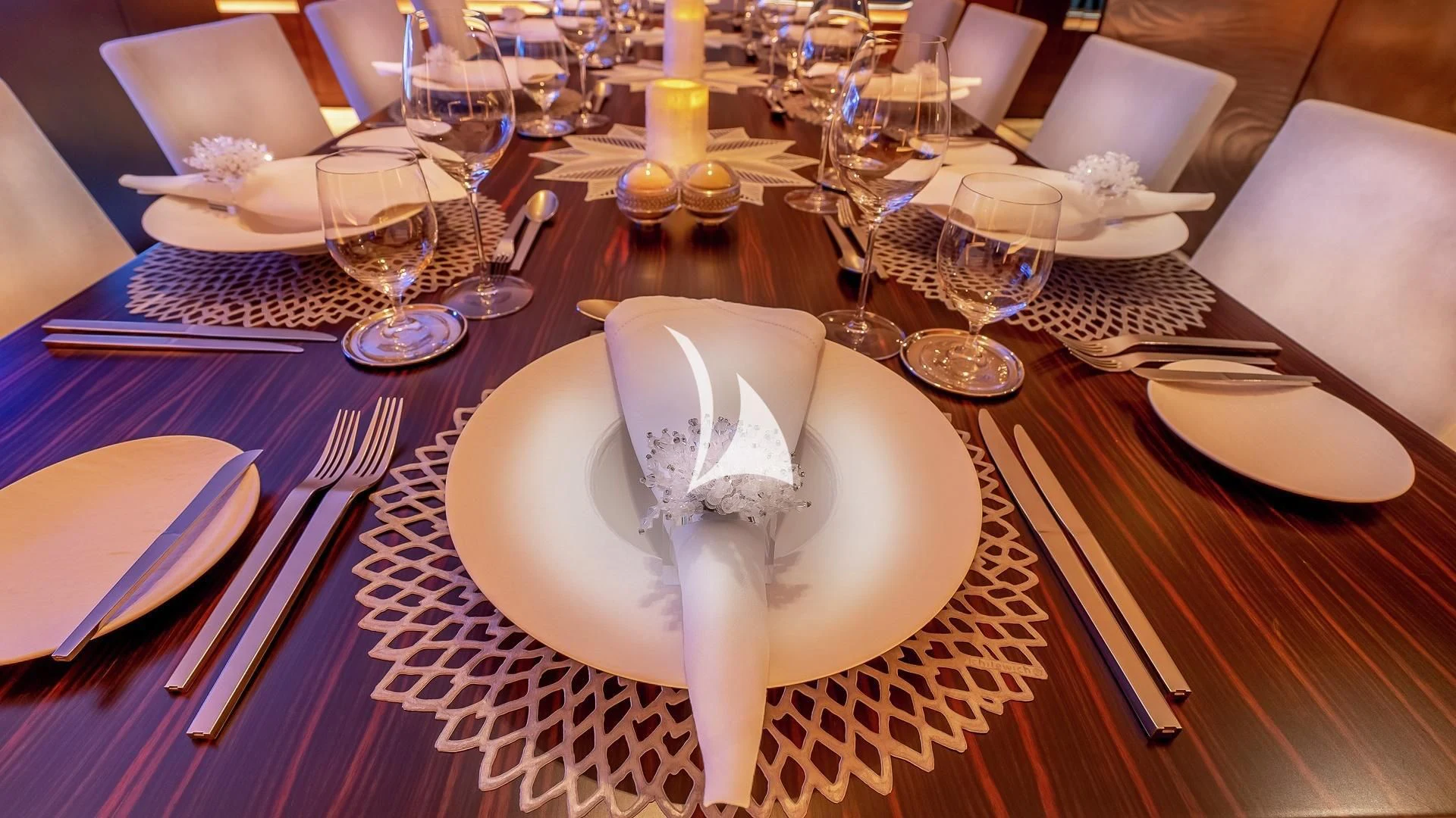 a table set with plates and silverware aboard ODESSA Yacht for Sale