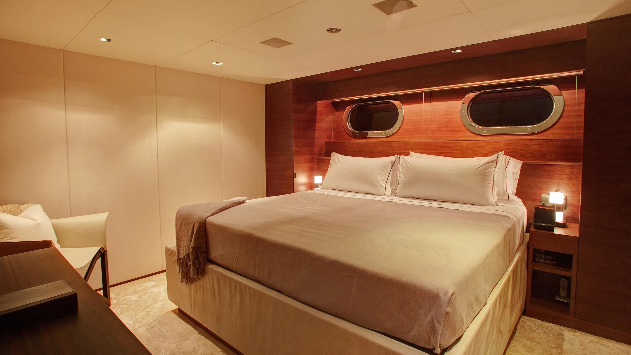 a bed with a white cover aboard ODESSA Yacht for Sale
