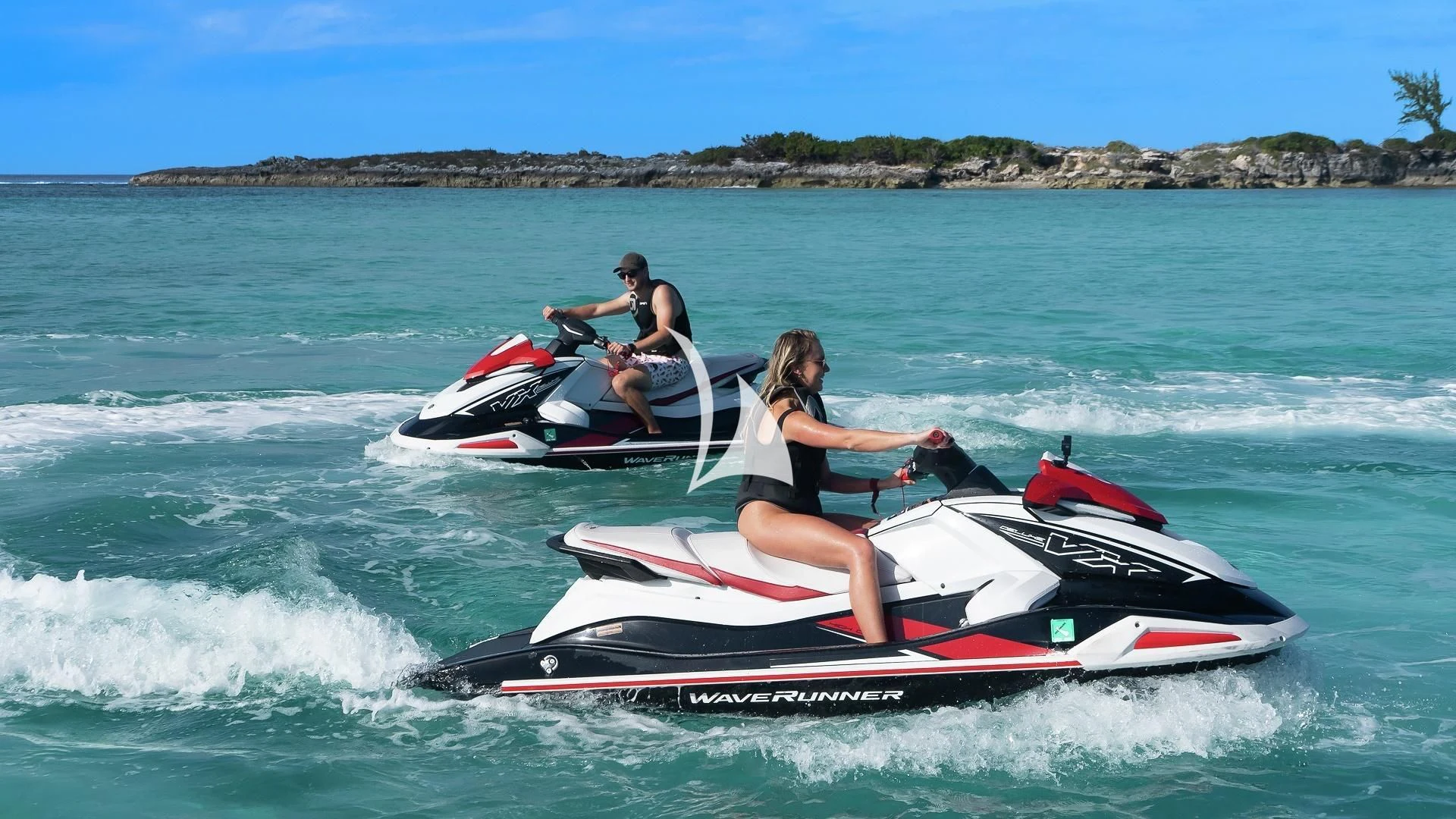 a couple of people on a jet ski in the water aboard ODESSA Yacht for Sale