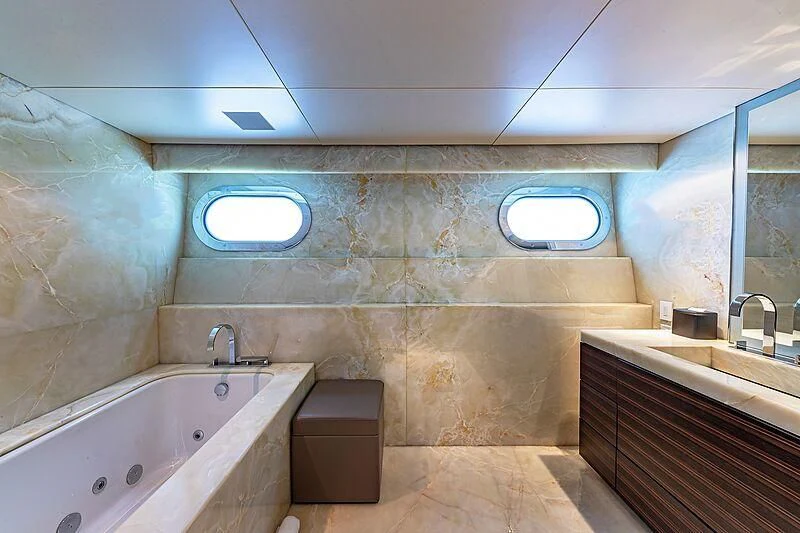 a bathroom with a tub and sinks aboard ODESSA Yacht for Sale
