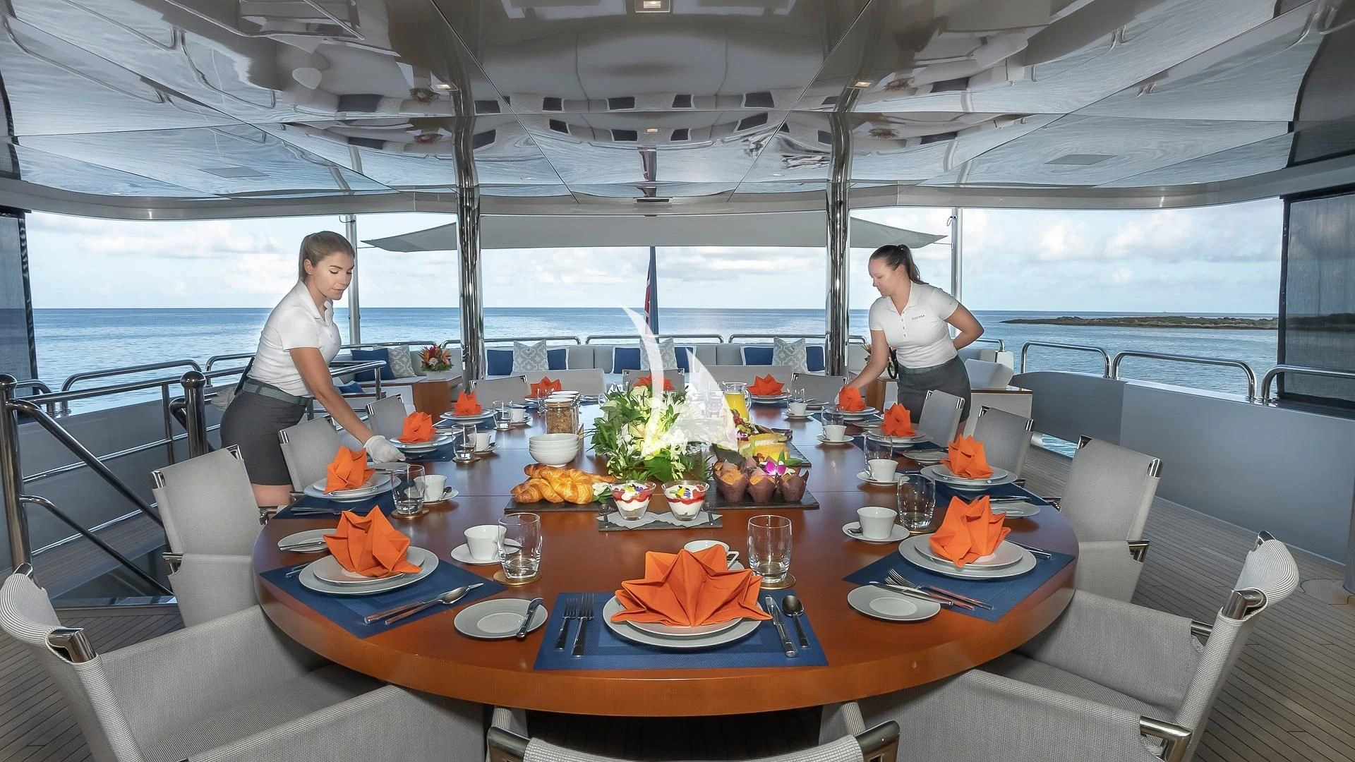 a couple of women working on a table in a tent aboard ODESSA Yacht for Sale