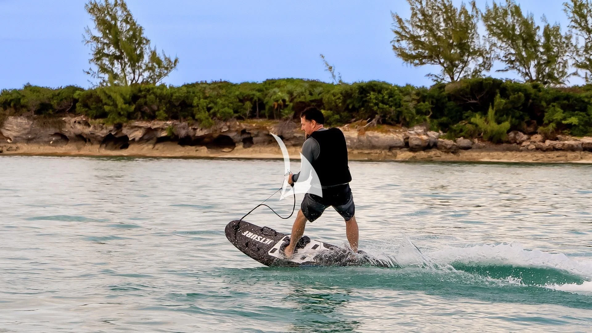 a man on a surfboard aboard ODESSA Yacht for Sale