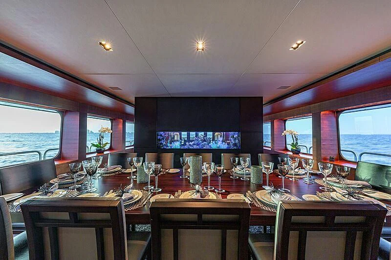 a table with glasses and wine bottles aboard ODESSA Yacht for Sale