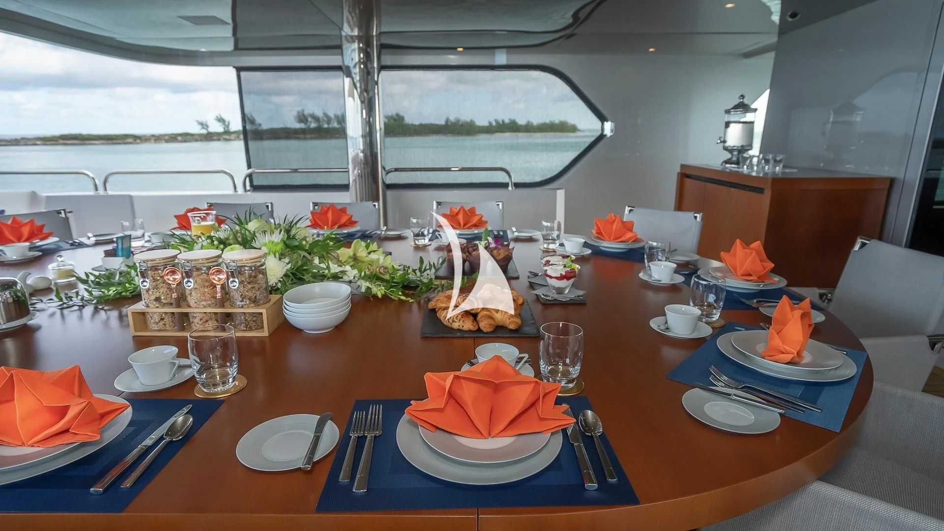 a table with plates and food on it aboard ODESSA Yacht for Sale