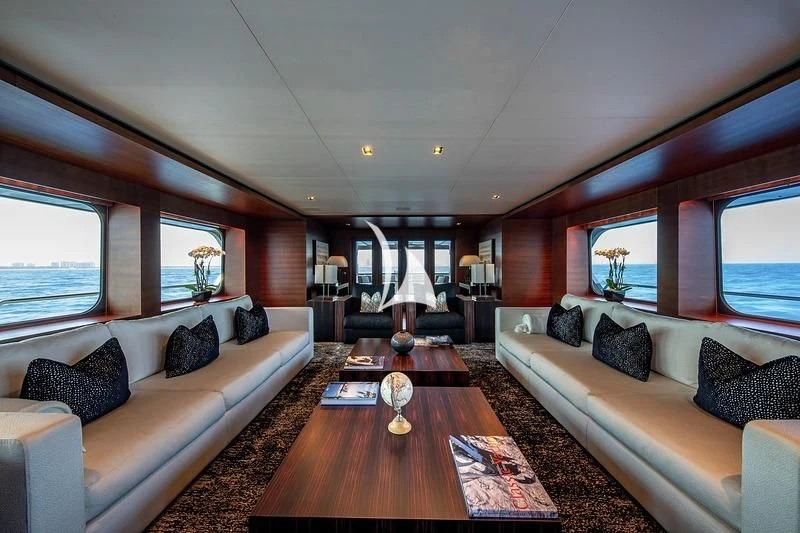 a living room with a large wood floor and a large window aboard ODESSA Yacht for Sale