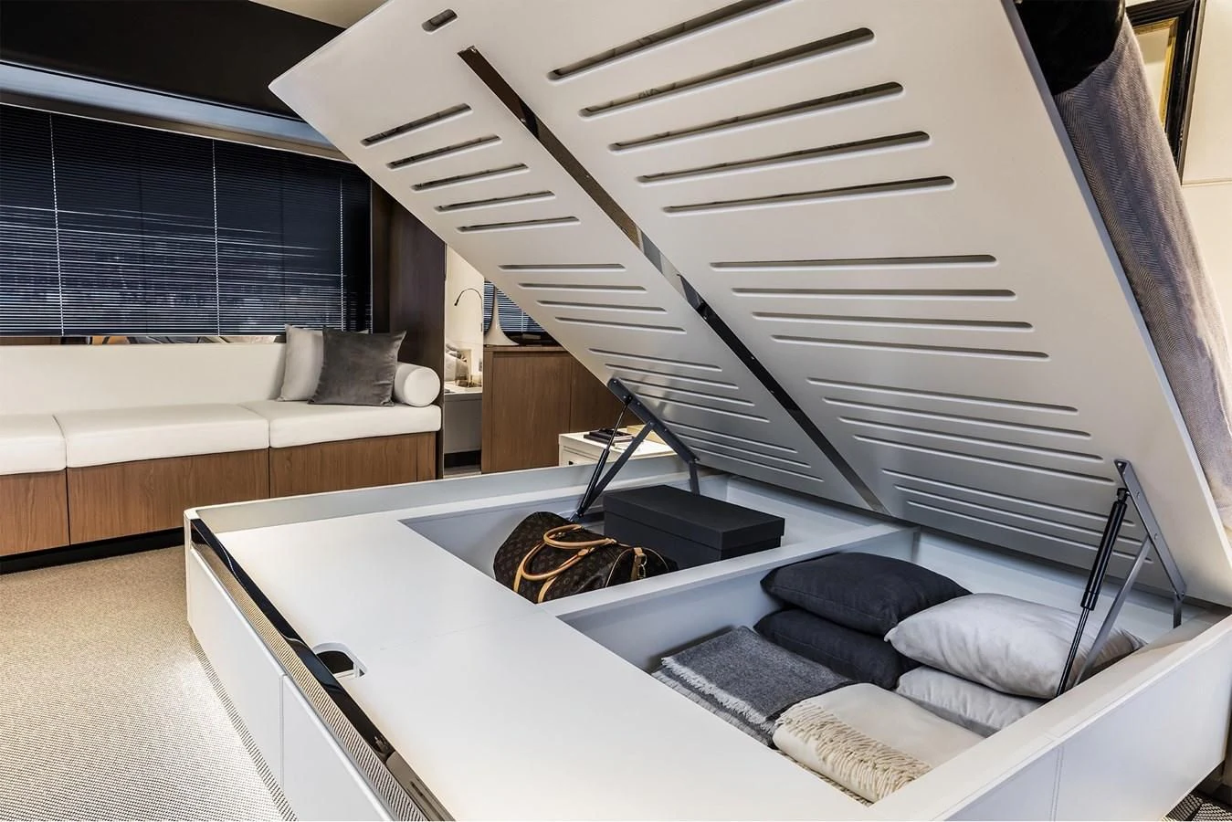 a room with a bed and a couch aboard RIVA 90' ARGO Yacht for Sale