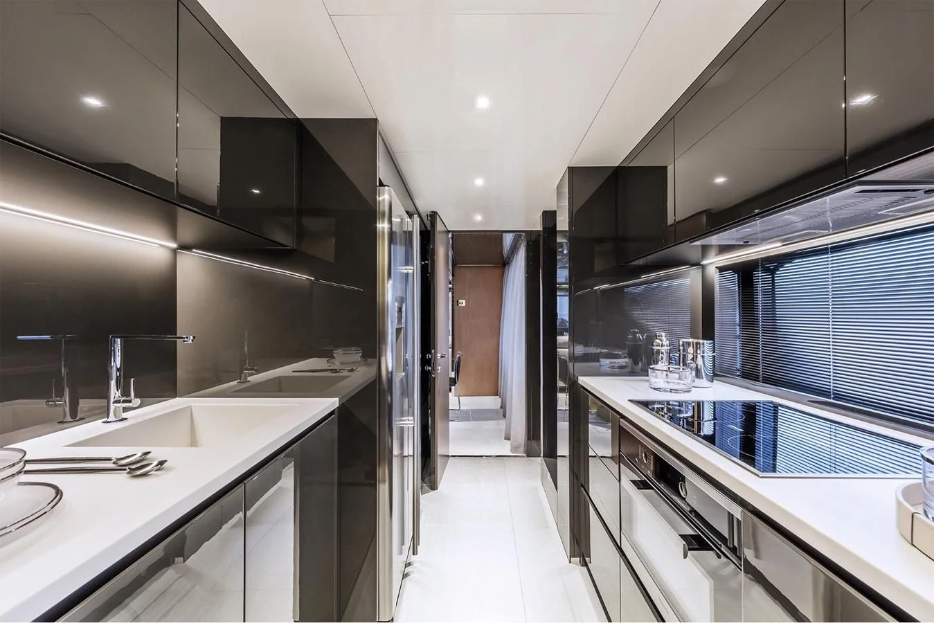 a modern kitchen with white cabinets aboard RIVA 90' ARGO Yacht for Sale
