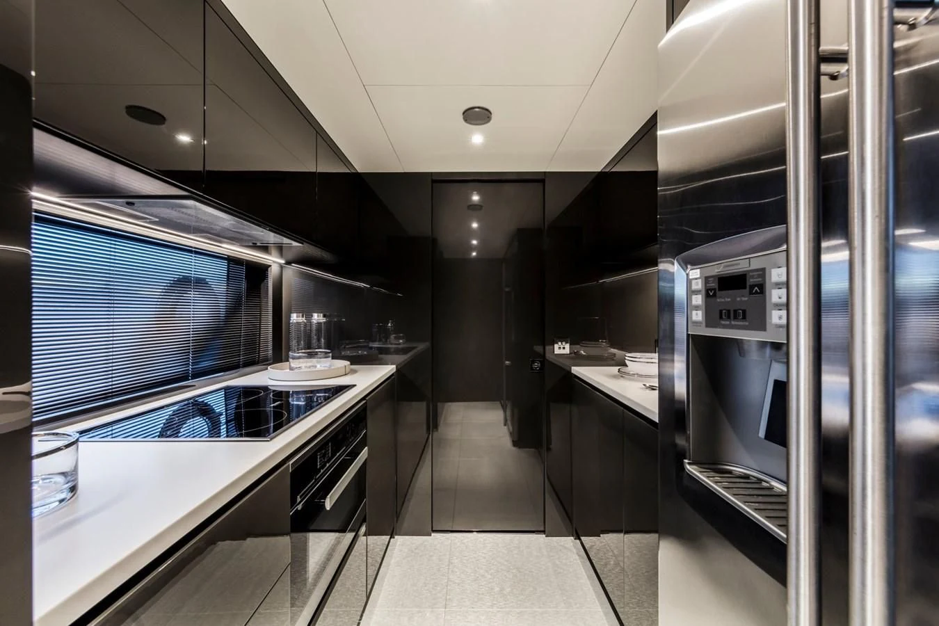 a modern kitchen with glass walls aboard RIVA 90' ARGO Yacht for Sale