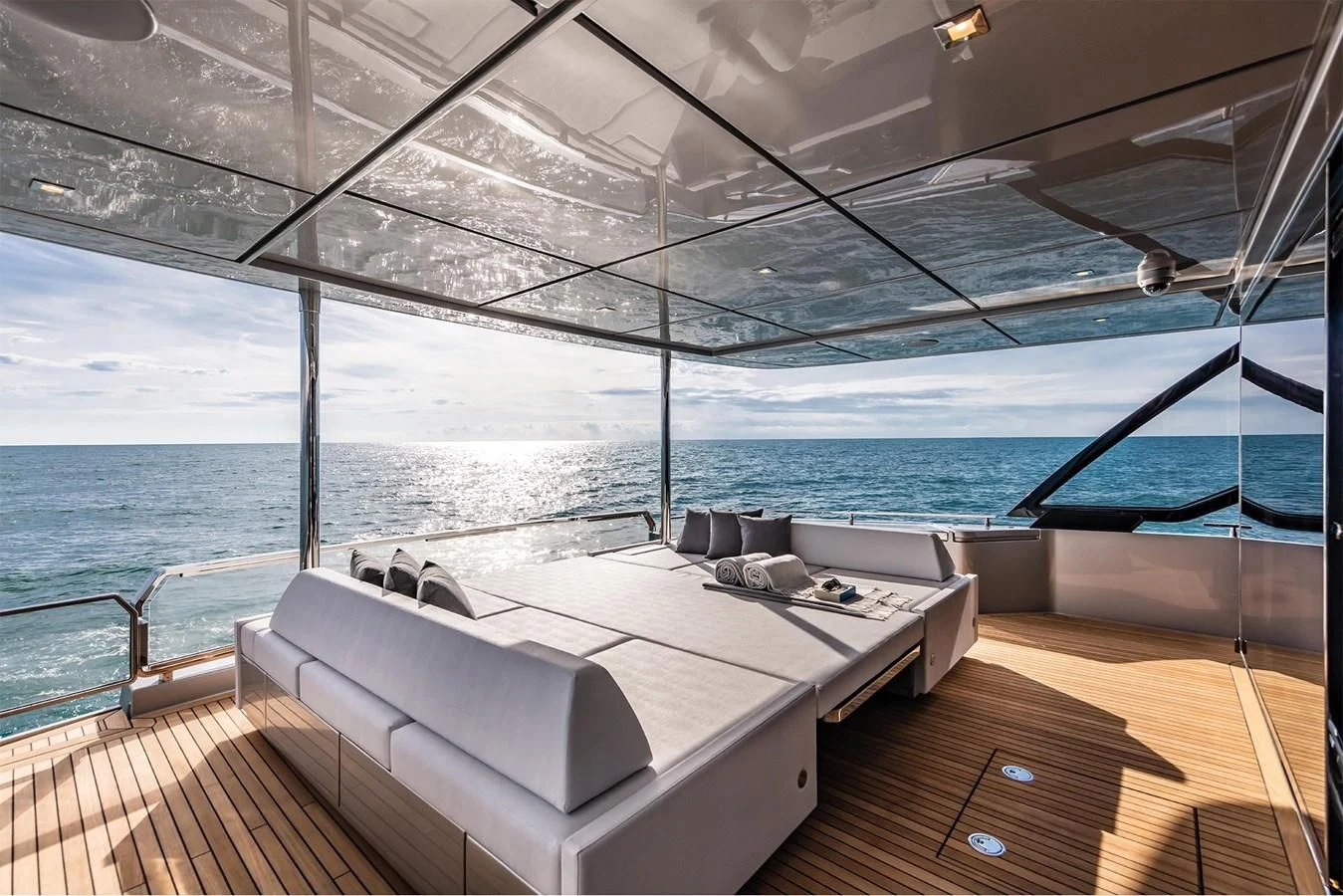 a room with a bed and a large window overlooking the ocean aboard RIVA 90' ARGO Yacht for Sale