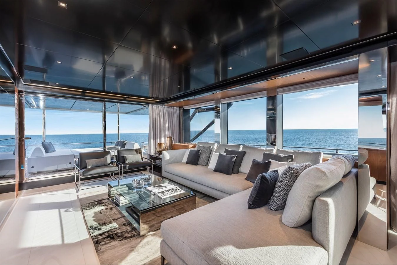 a living room with a large window aboard RIVA 90' ARGO Yacht for Sale