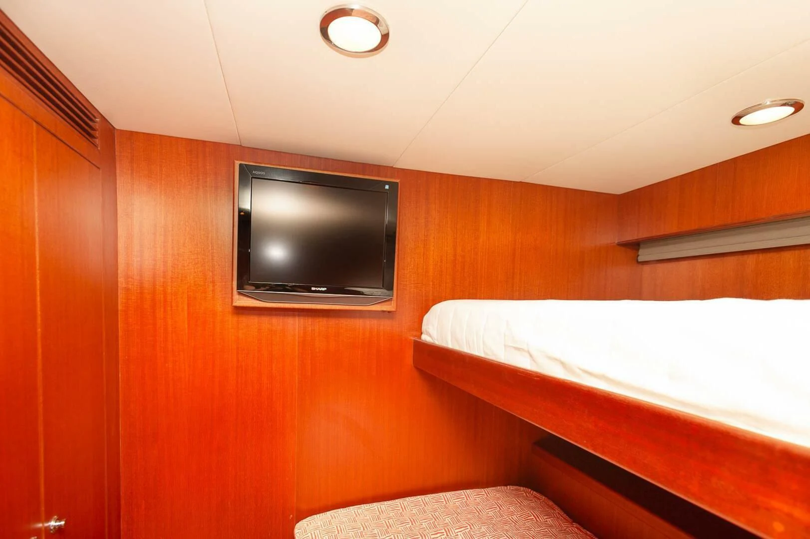 a room with a tv and a bed aboard COCONUT Yacht for Sale
