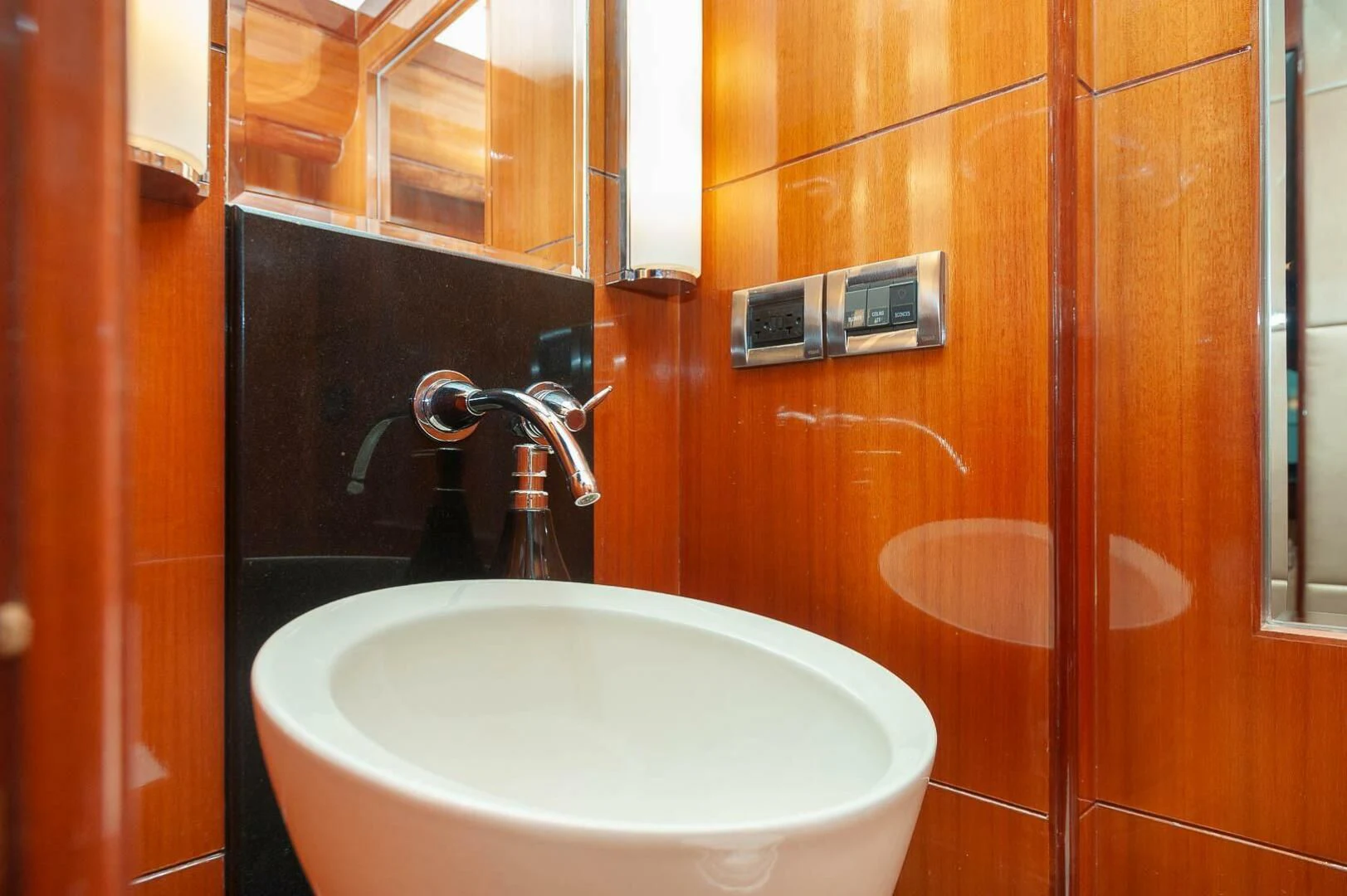 a bathroom with a sink and a mirror aboard COCONUT Yacht for Sale