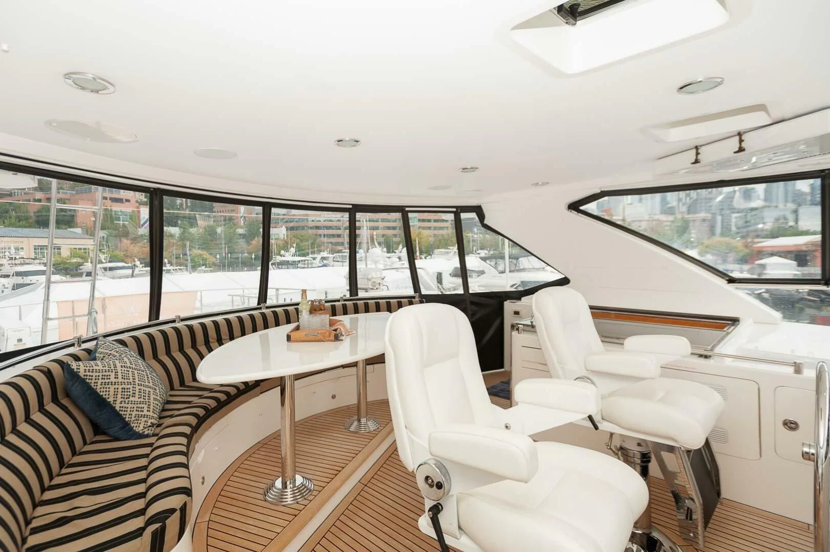 a room with a table chairs and a window with a view of the city aboard COCONUT Yacht for Sale