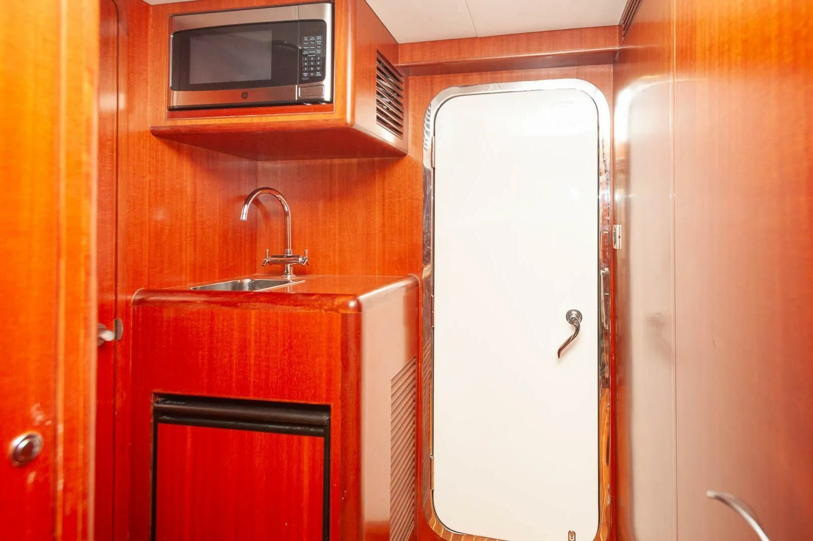 a kitchen with a sink and microwave aboard COCONUT Yacht for Sale