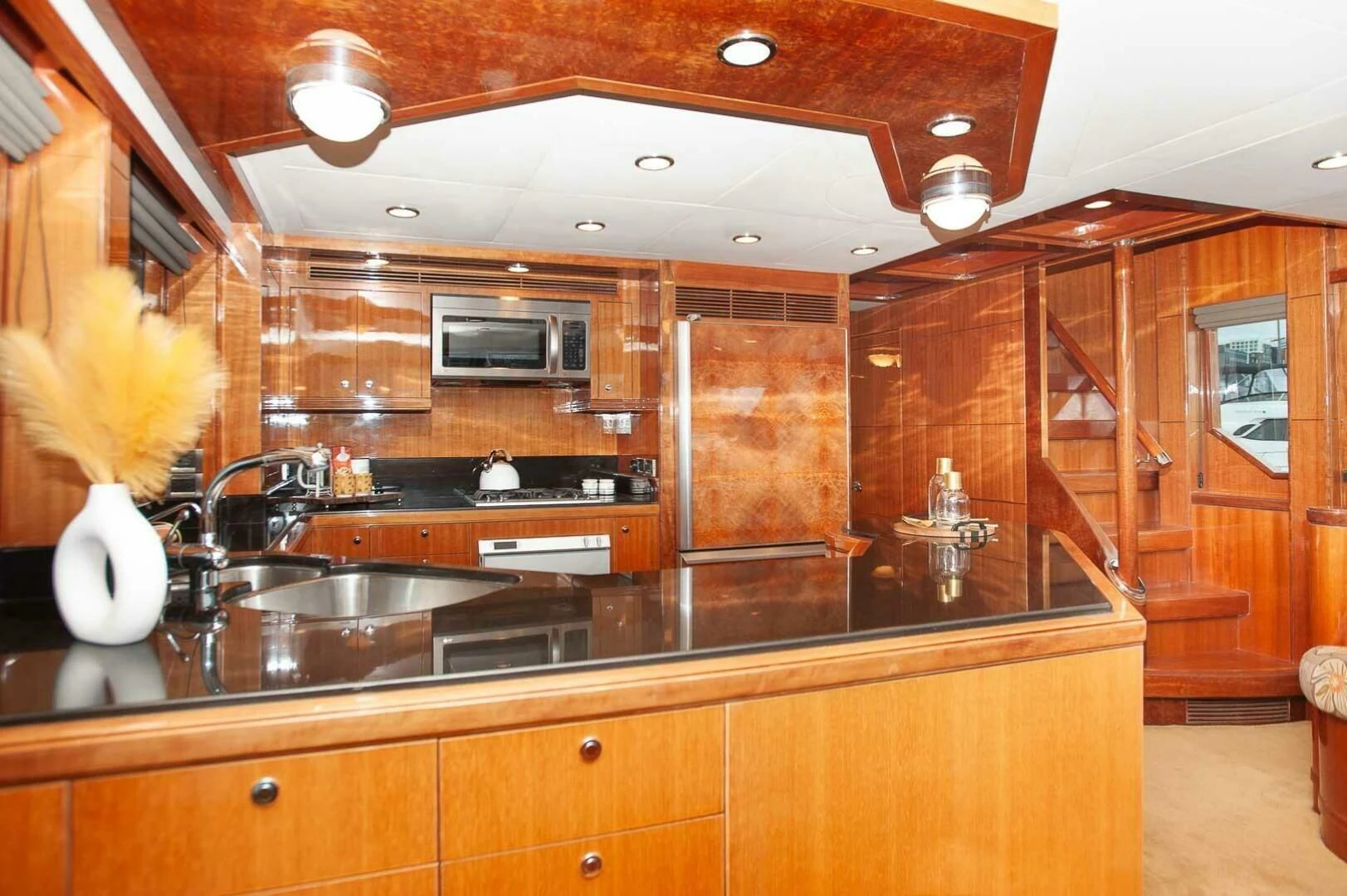 a kitchen with wooden cabinets aboard COCONUT Yacht for Sale