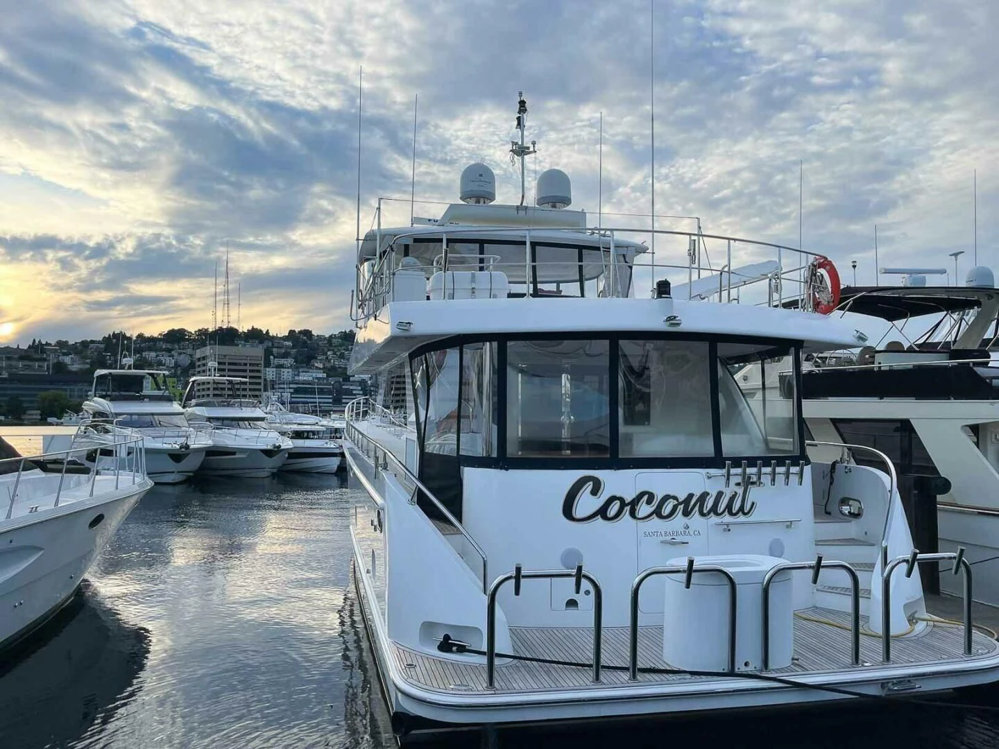 a boat is parked in a harbor aboard COCONUT Yacht for Sale