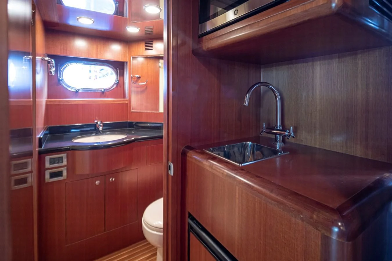 a kitchen with wooden cabinets aboard COCONUT Yacht for Sale