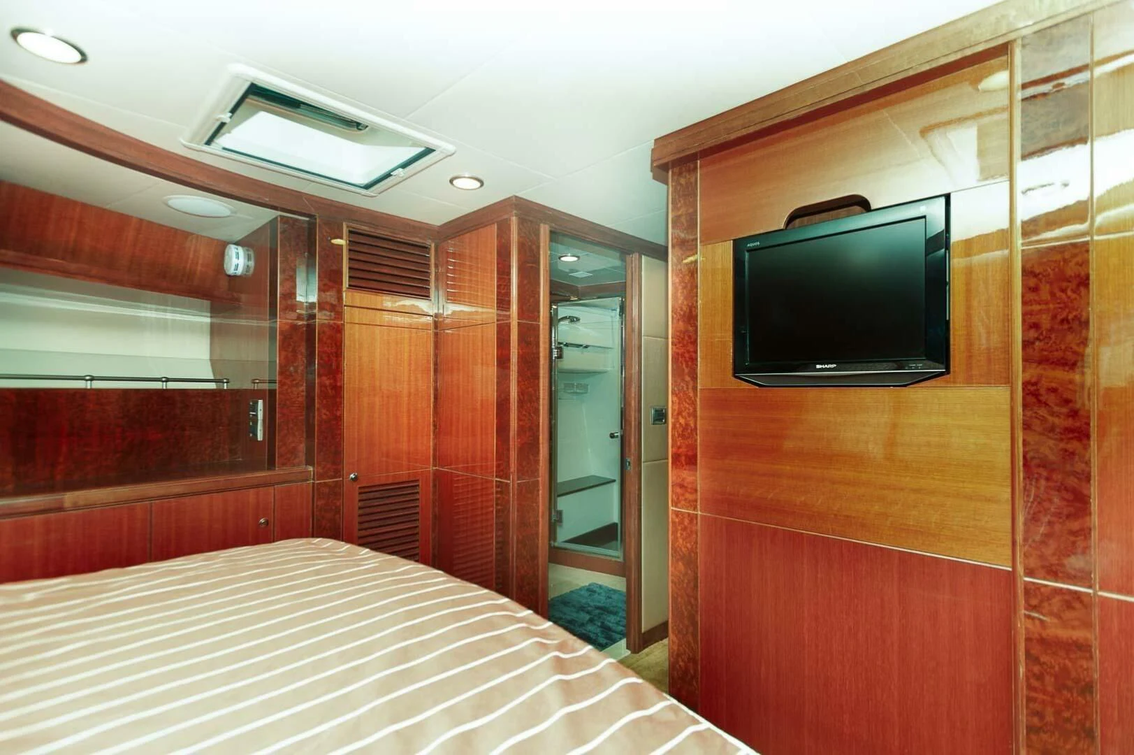 a room with a tv and a bed aboard COCONUT Yacht for Sale