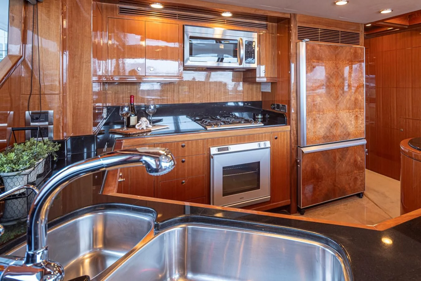 a kitchen with wooden cabinets aboard COCONUT Yacht for Sale