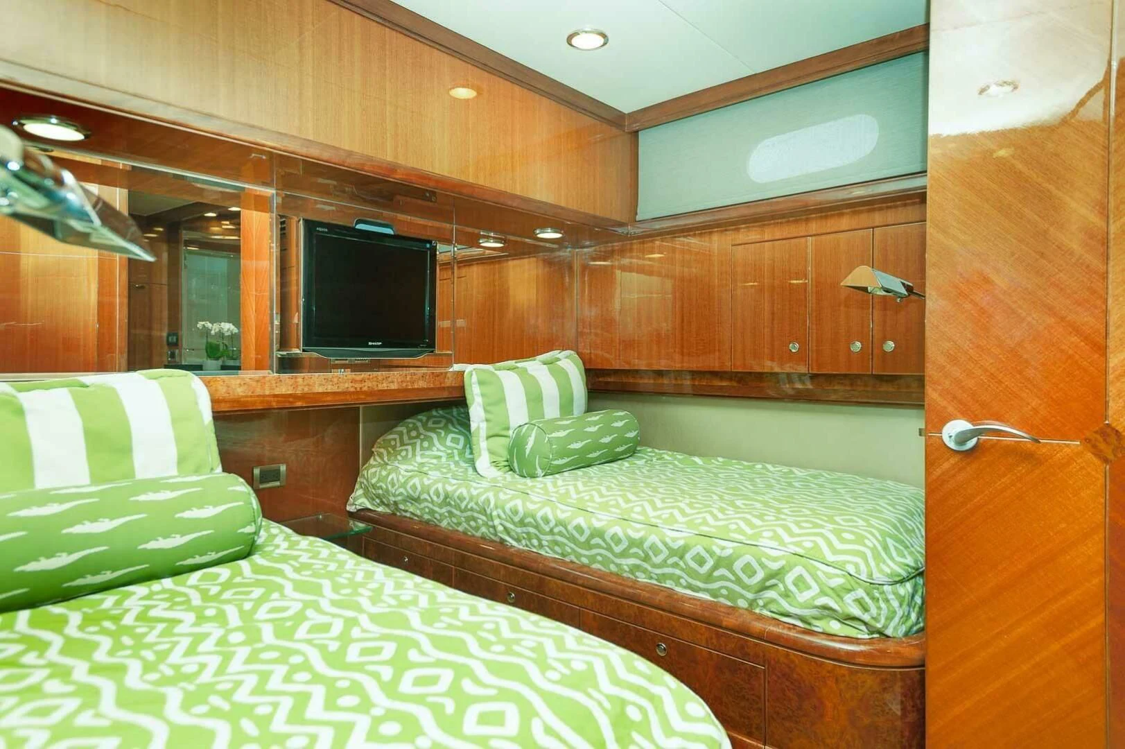 a room with a bed and a television aboard COCONUT Yacht for Sale