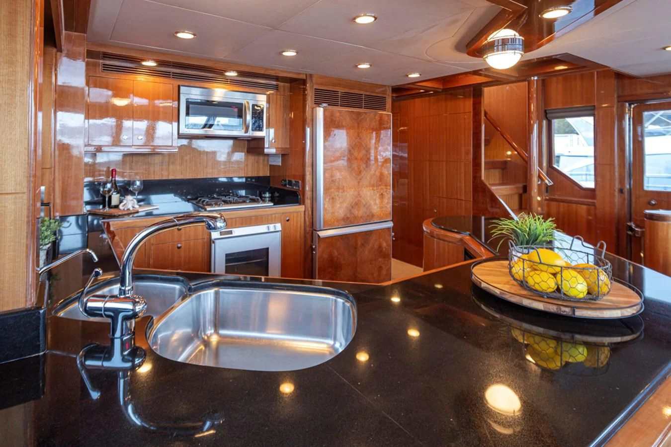 a kitchen with a sink and a large island aboard COCONUT Yacht for Sale