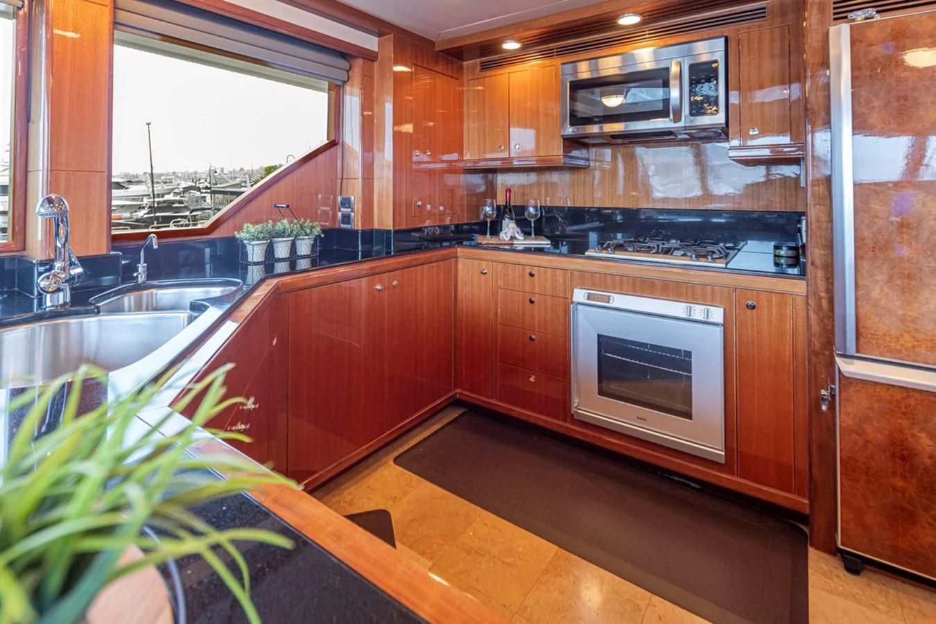 a kitchen with wooden cabinets aboard COCONUT Yacht for Sale