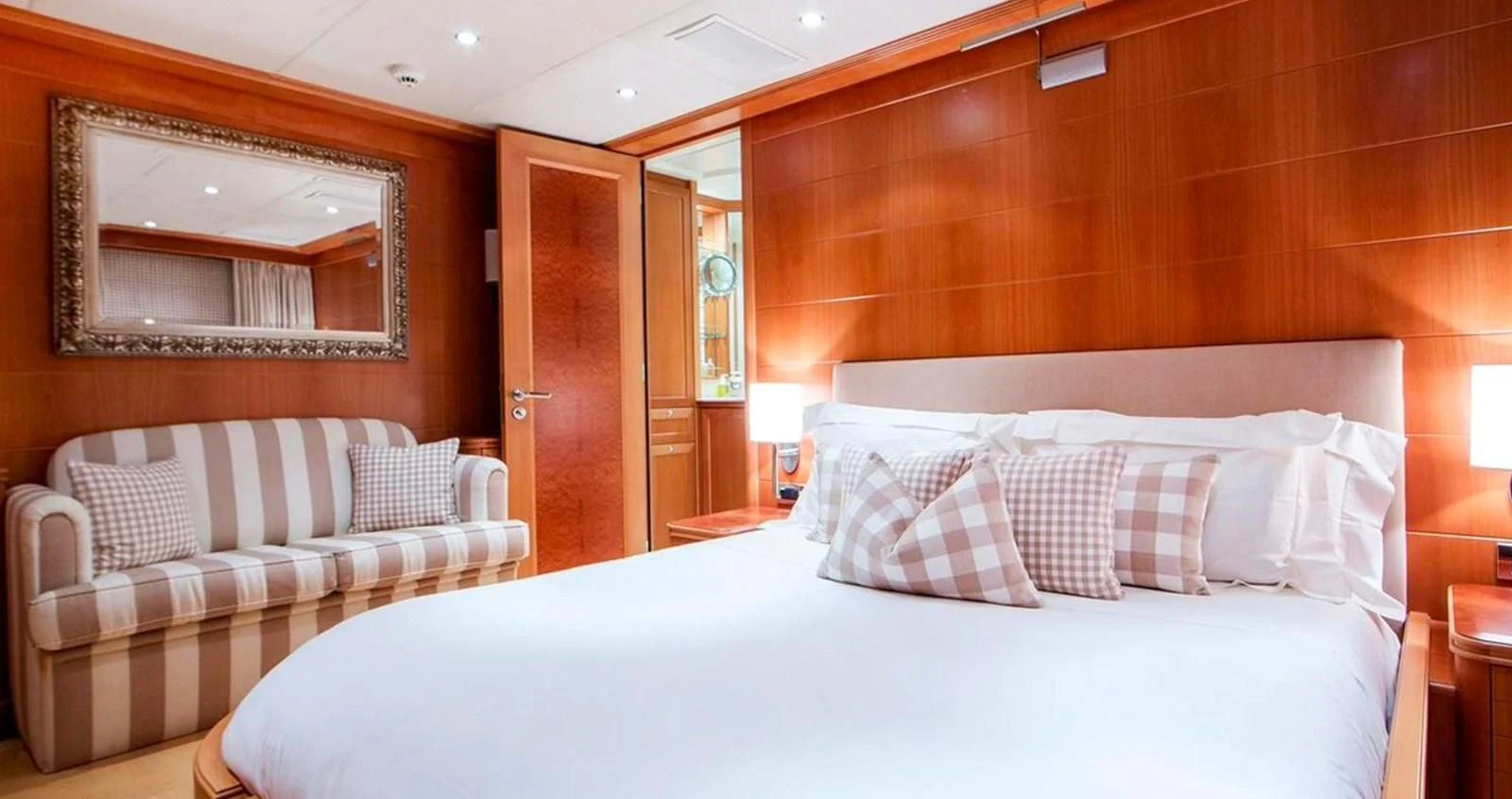 a room with a bed and a couch aboard BENIK Yacht for Charter
