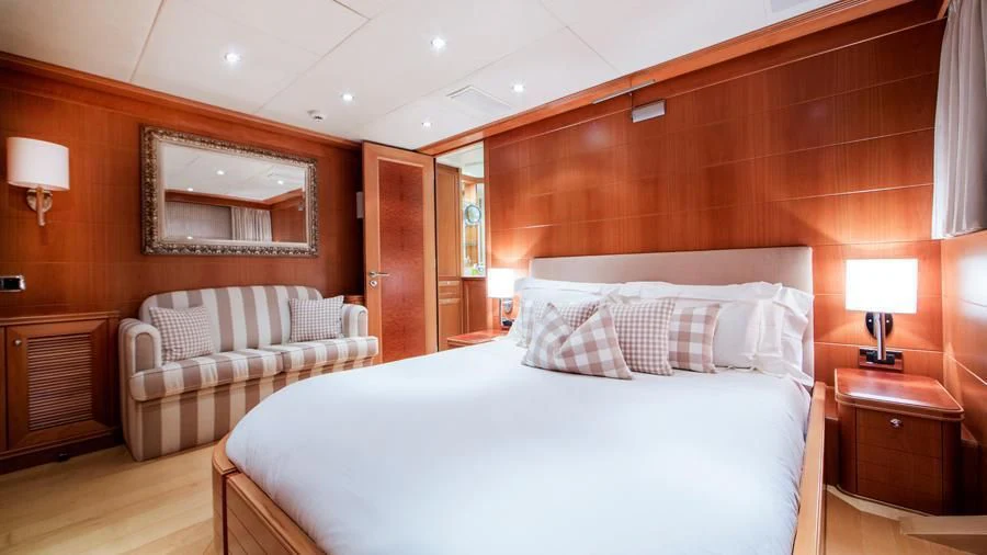 a room with a bed and a mirror aboard BENIK Yacht for Charter