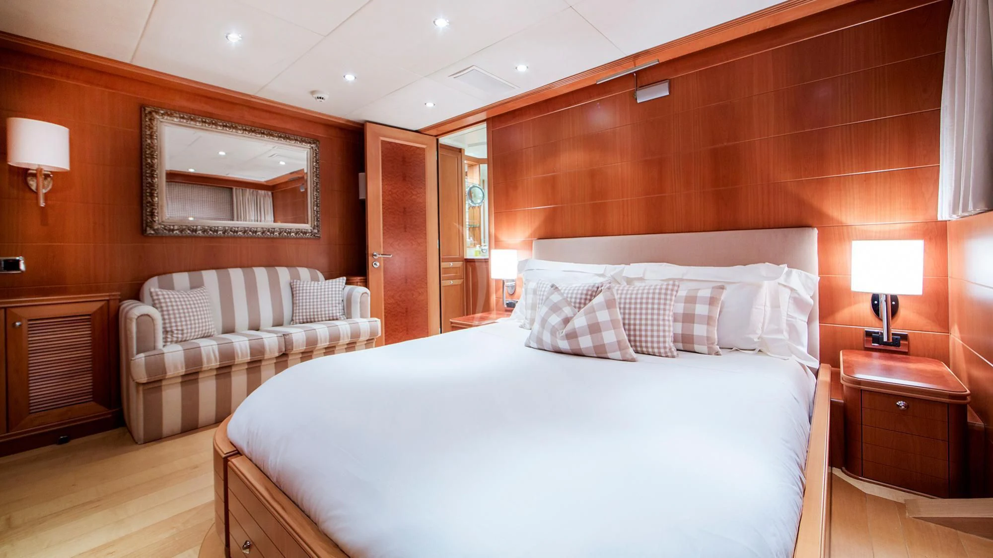 a room with a bed and a mirror aboard BENIK Yacht for Charter