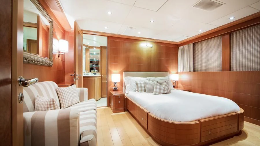 a room with a bed and a mirror aboard BENIK Yacht for Charter
