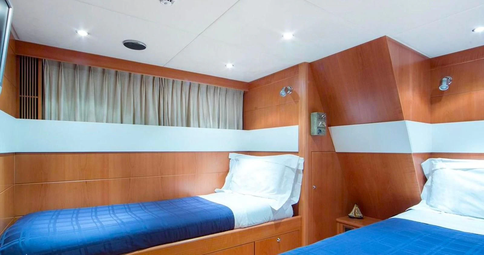 a room with a bed and a wood wall aboard BENIK Yacht for Charter