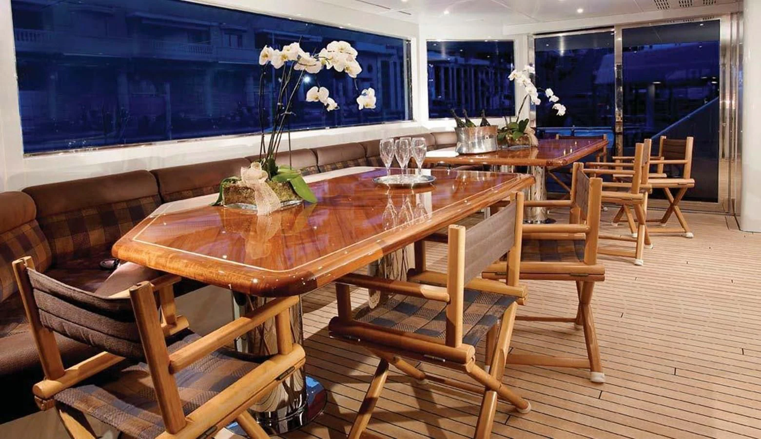 a wooden table with chairs around it aboard BENIK Yacht for Charter