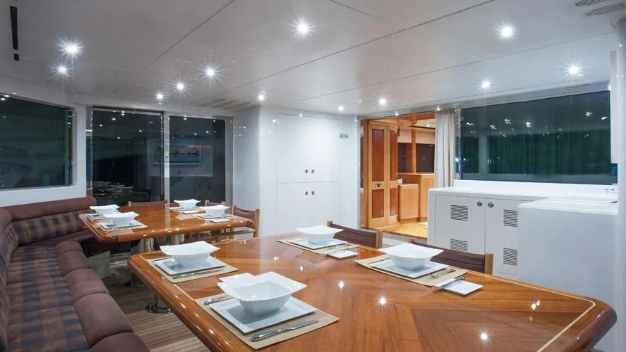 a large kitchen with a table and chairs aboard BENIK Yacht for Charter