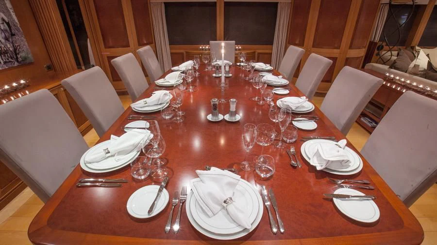 a table set with plates and silverware aboard BENIK Yacht for Charter