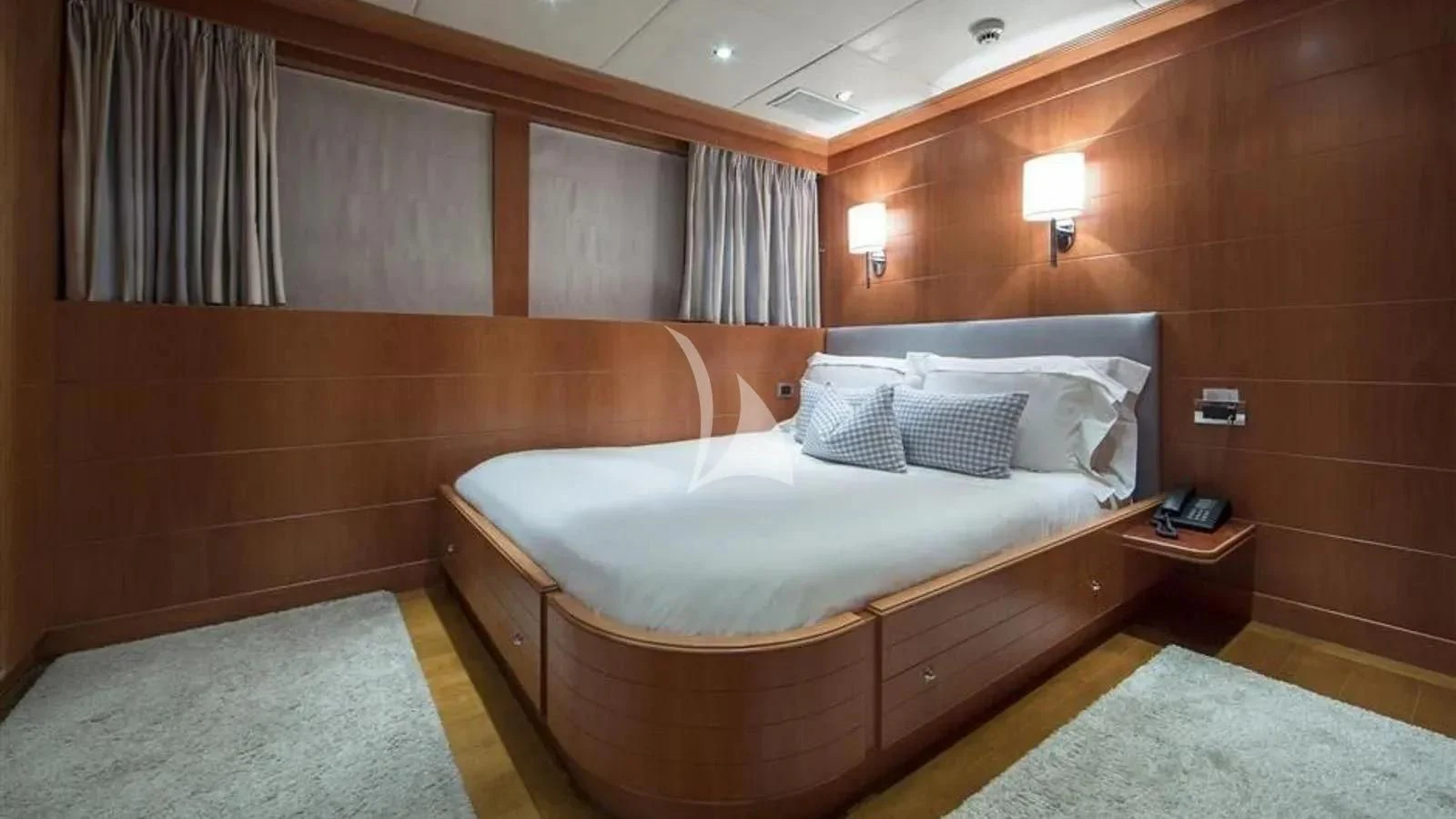 a room with a bed and a desk aboard BENIK Yacht for Charter