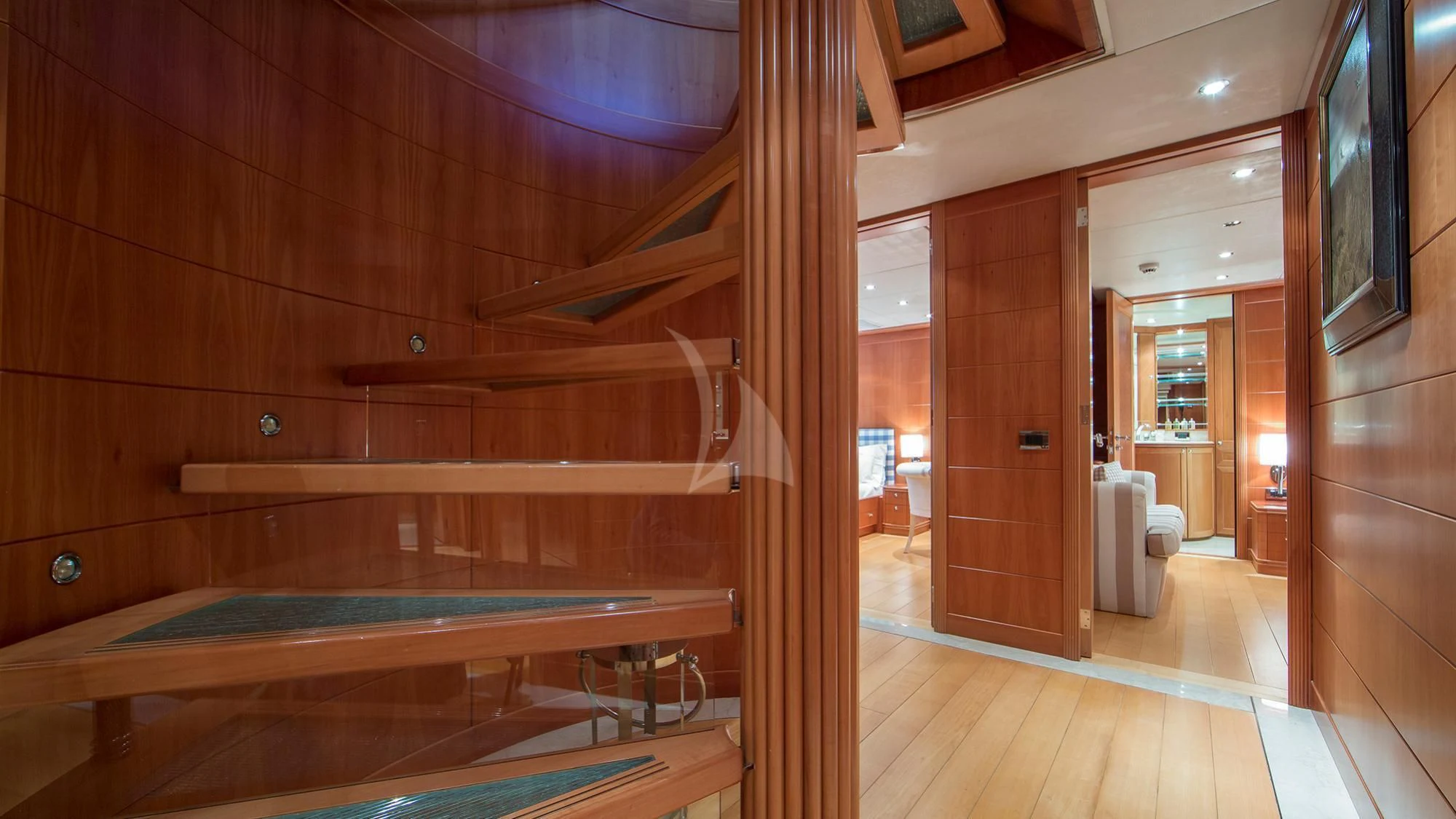 a room with a wood bed and a wood door aboard BENIK Yacht for Charter