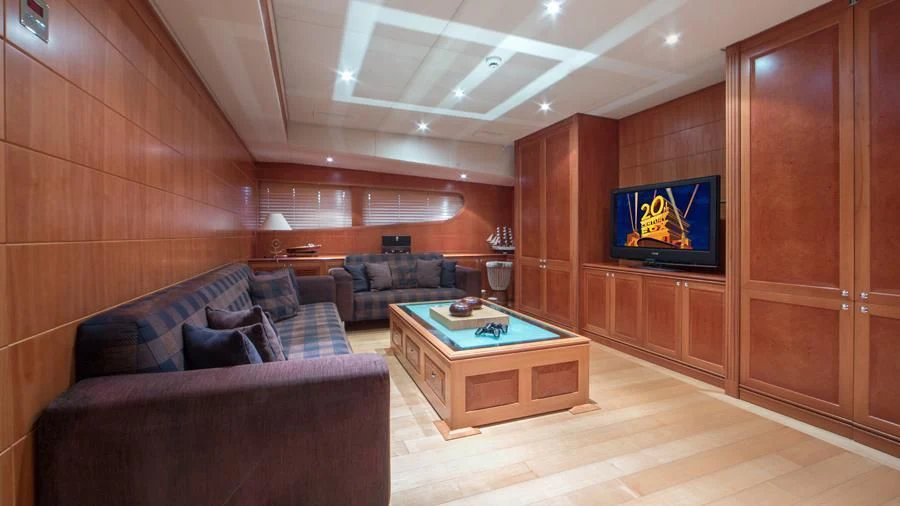 a living room with a tv and couches aboard BENIK Yacht for Charter