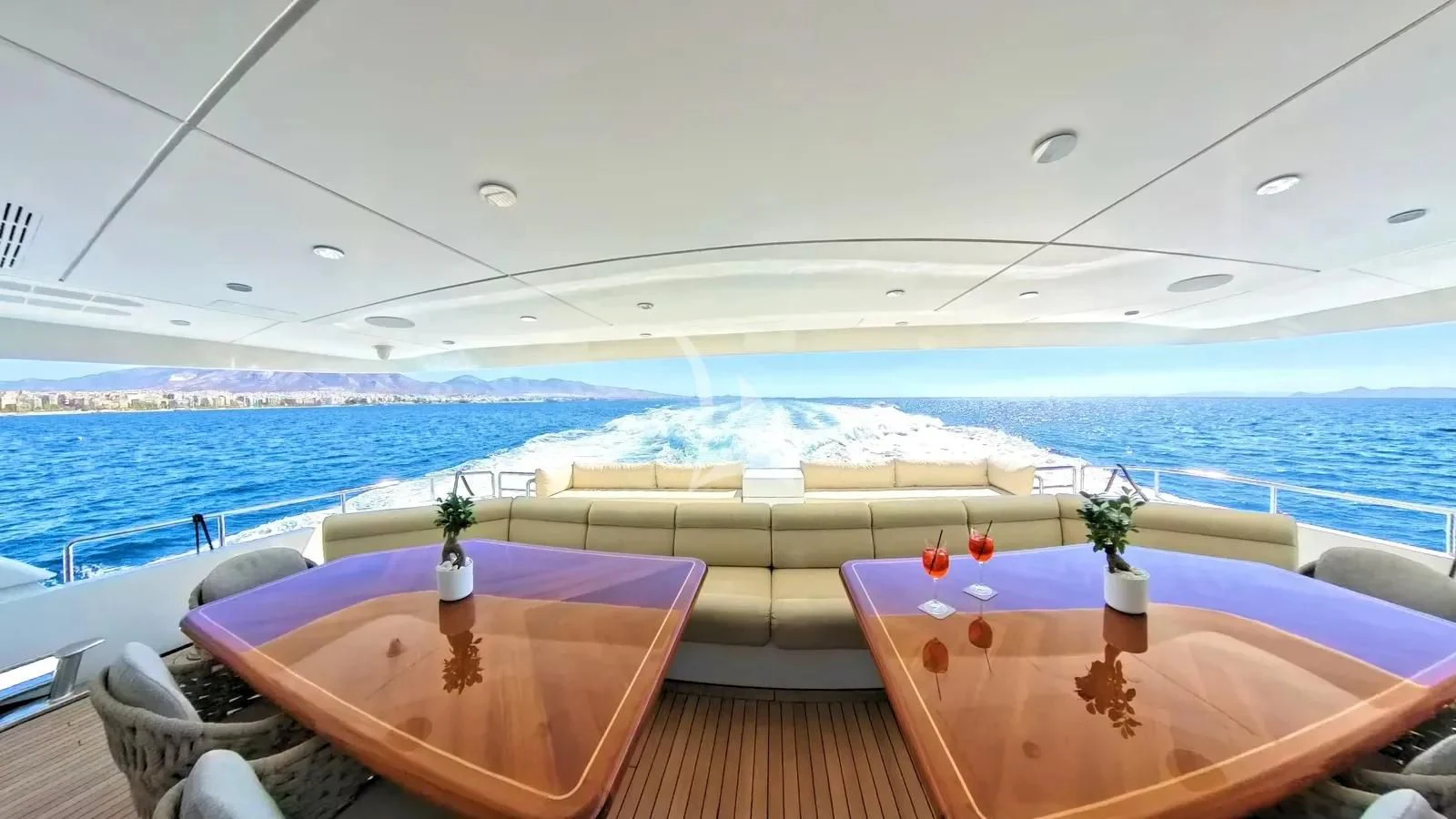 a deck with a view of the ocean and a beach aboard BENIK Yacht for Charter