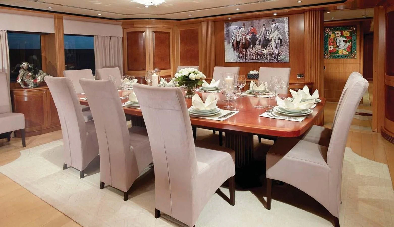 a dining room with white chairs aboard BENIK Yacht for Charter